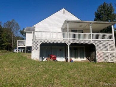 Side of property with a lawn and a deck