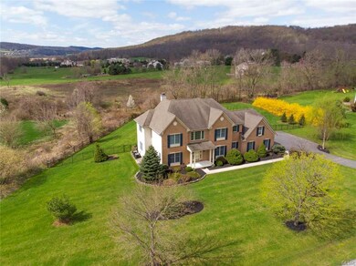 Set amidst rolling hills on 1.4 acres in establish