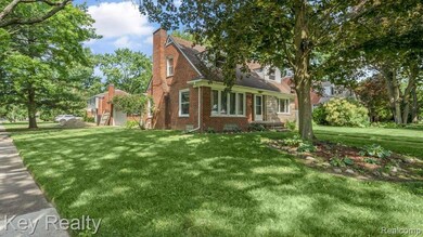 Corner lot view highlighting the home’s elegant brickwork, pitched roofline,