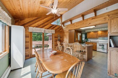 Tiled dining area with ceiling fan, wooden ceiling
