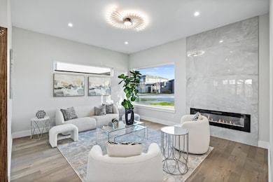 Living room with a fireplace, wood finished floors, and recessed lighting