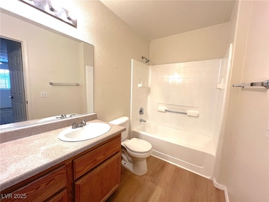 Full bathroom featuring wood finished floors, toil