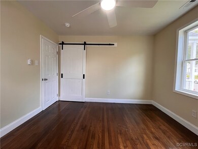 Primary bedroom with refinished wood floors, ceili