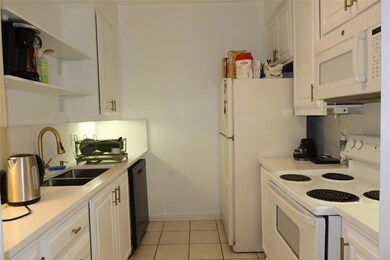Kitchen featuring white appliances, white cabinet