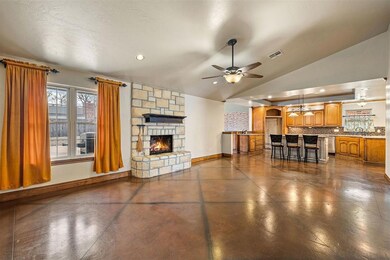 Living room with limestone fireplace and stained c