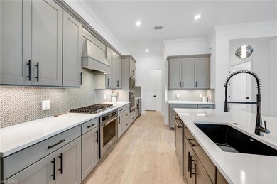 Kitchen with custom range hood, sink, crown moldin