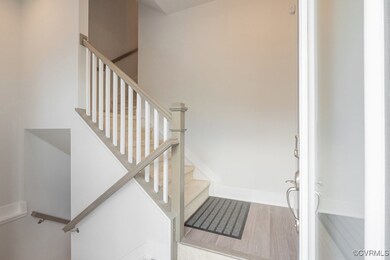 Staircase with wood finished floors and baseboards