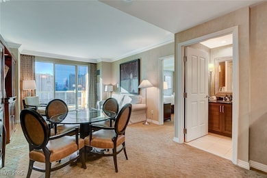 Dining area featuring a view of city, crown moldin