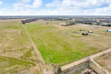 Birds eye view of property featuring a rural view