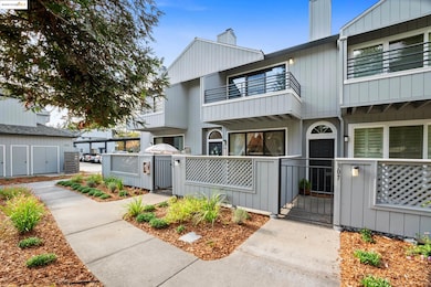 View of front facade featuring a gate, a chimney, a fenced front yard, and board and batten siding