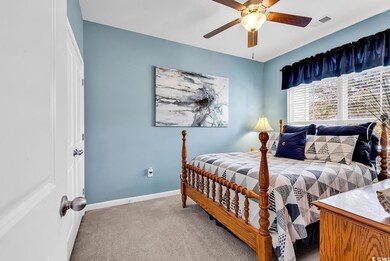 Carpeted bedroom with ceiling fan