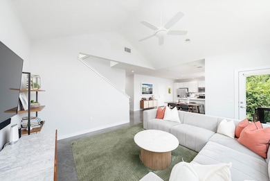 Living room featuring ceiling fan, high vaulted c