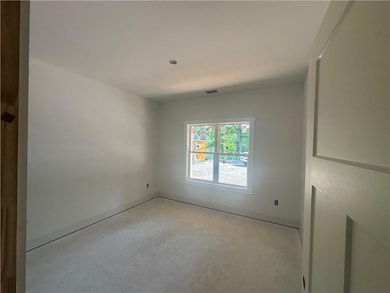 Empty room with concrete flooring and baseboards
