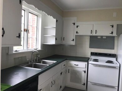 White kitchen with black counters.