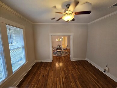 Empty room featuring crown molding, a healthy amou