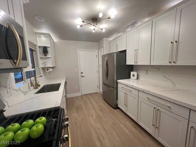 Kitchen featuring light wood finished floors, visi
