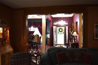 Foyer featuring an inviting chandelier and crown m