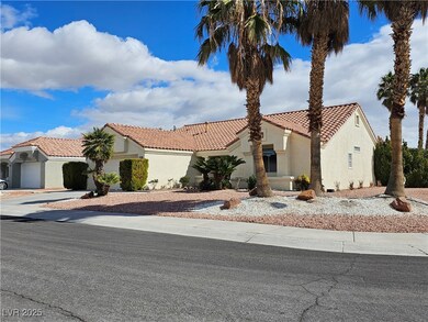 View of front of home with driveway, a tiled roof,