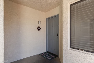 Entrance to property featuring stucco siding