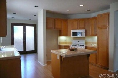 Looking from the den into the kitchen and kitchen 