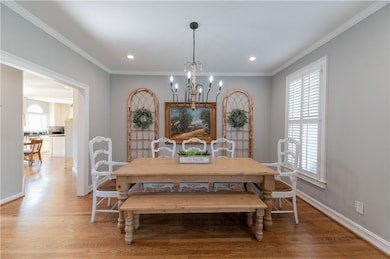 Dining room with light wood-style flooring, orname