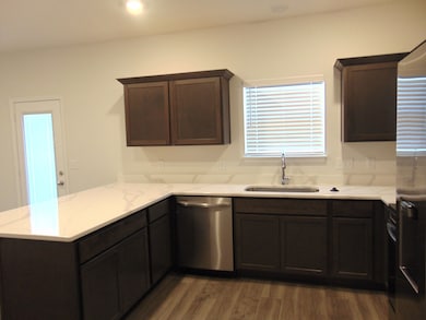 This is a sleek and modern kitchen to cook your family meals has stainless steel appliances and staggered cabinetry, as well as dreamy crowns