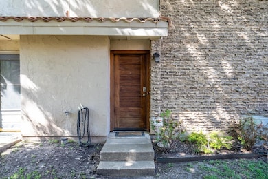 View of exterior entry with stucco siding