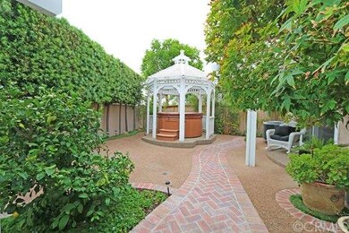 Lush landscaping keeps the gazebo and above-ground spa a private place to relax.