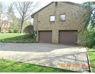 Exterior Back. Two car garage and omni stone drive