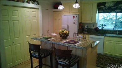 Chef's kitchen with pantry and island with granite