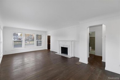Unfurnished living room with dark wood-type flooring and a fireplace