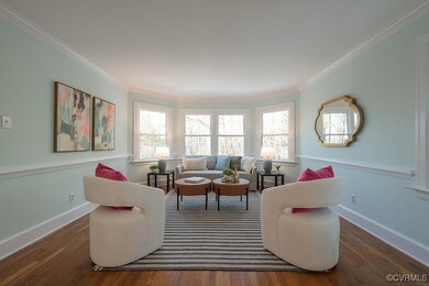 Your well appointed living room w/bay windows offe