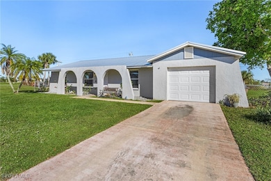 Ranch-style home with a front yard and a garage