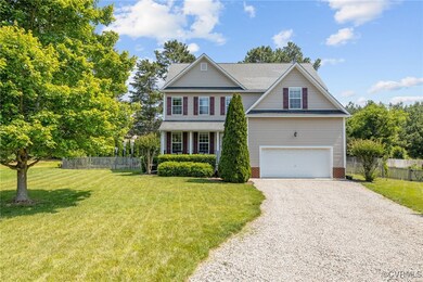 Traditional home with gravel driveway and an attac
