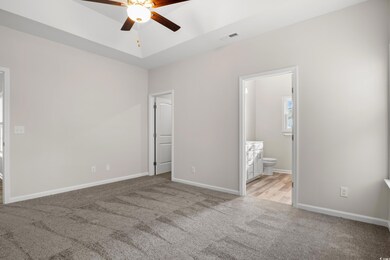 Unfurnished bedroom featuring ensuite bath, basebo
