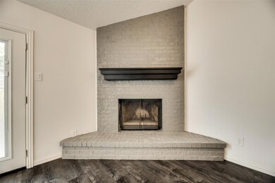 Interior details with wood-type flooring, a brick 