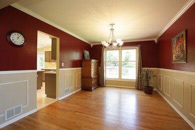 Formal dining room with hardwood floors, chair rai