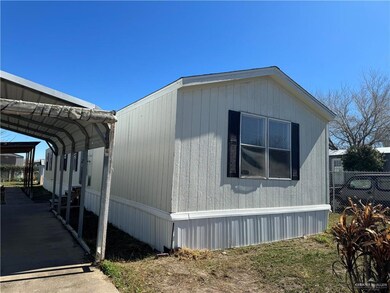 View of side of property with a carport