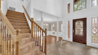 Soaring two-story entry way with beautiful windows