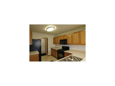 Kitchen. Oak kitchen cabinets, stove, refrigerator