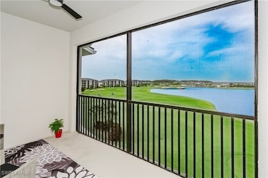Sunroom with a water view and golf course view
