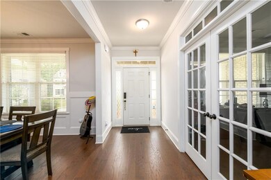 Entryway with french doors, dark wood-style floors