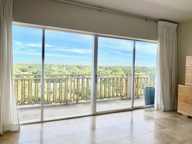 Bedroom also has wall of windows and access to bal