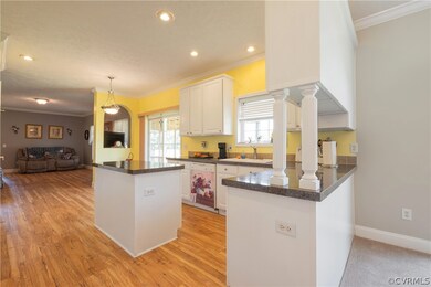Kitchen featuring light wood-style floors, island,
