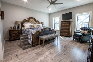Bedroom with wood finished floors, a ceiling fan, and recessed lighting
