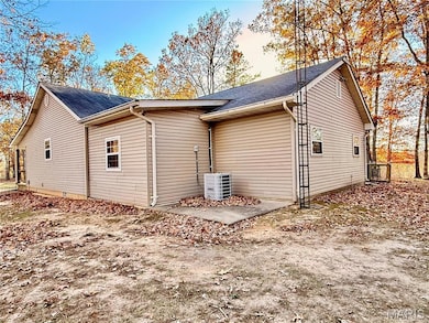 View of home's exterior with roof with shingles and a cooling unit