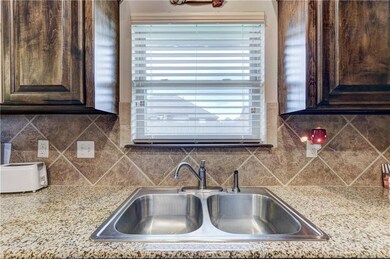 Stainless steel sink with a window that looks out 