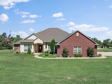 Ranch-style house featuring a front lawn, brick siding, and stone siding