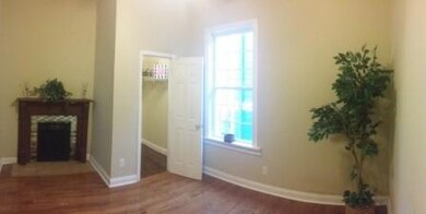 Entrance foyer with healthy amount of natural light, wood finished floors, and baseboards