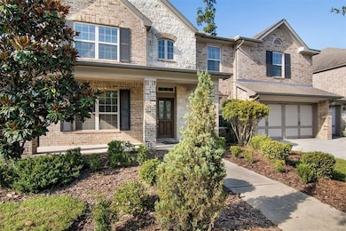 Beautifully landscaped front yard with large drive